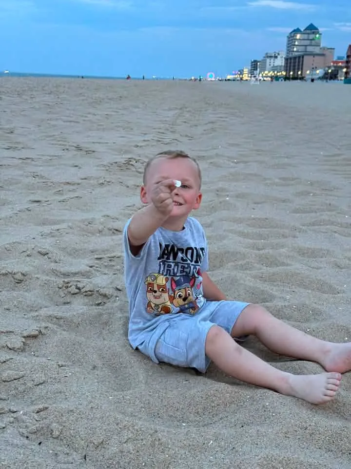 boy with sea shell in ocean city md