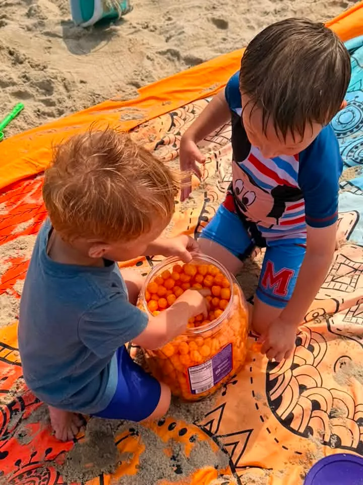 kids on beach eating cheese balls