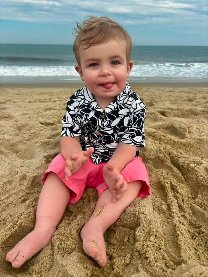 baby on the beach in ocean city md eating sand