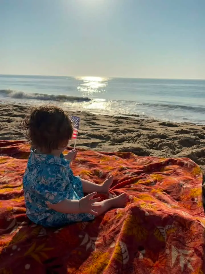 Baby on the beach in ocean city md with flag