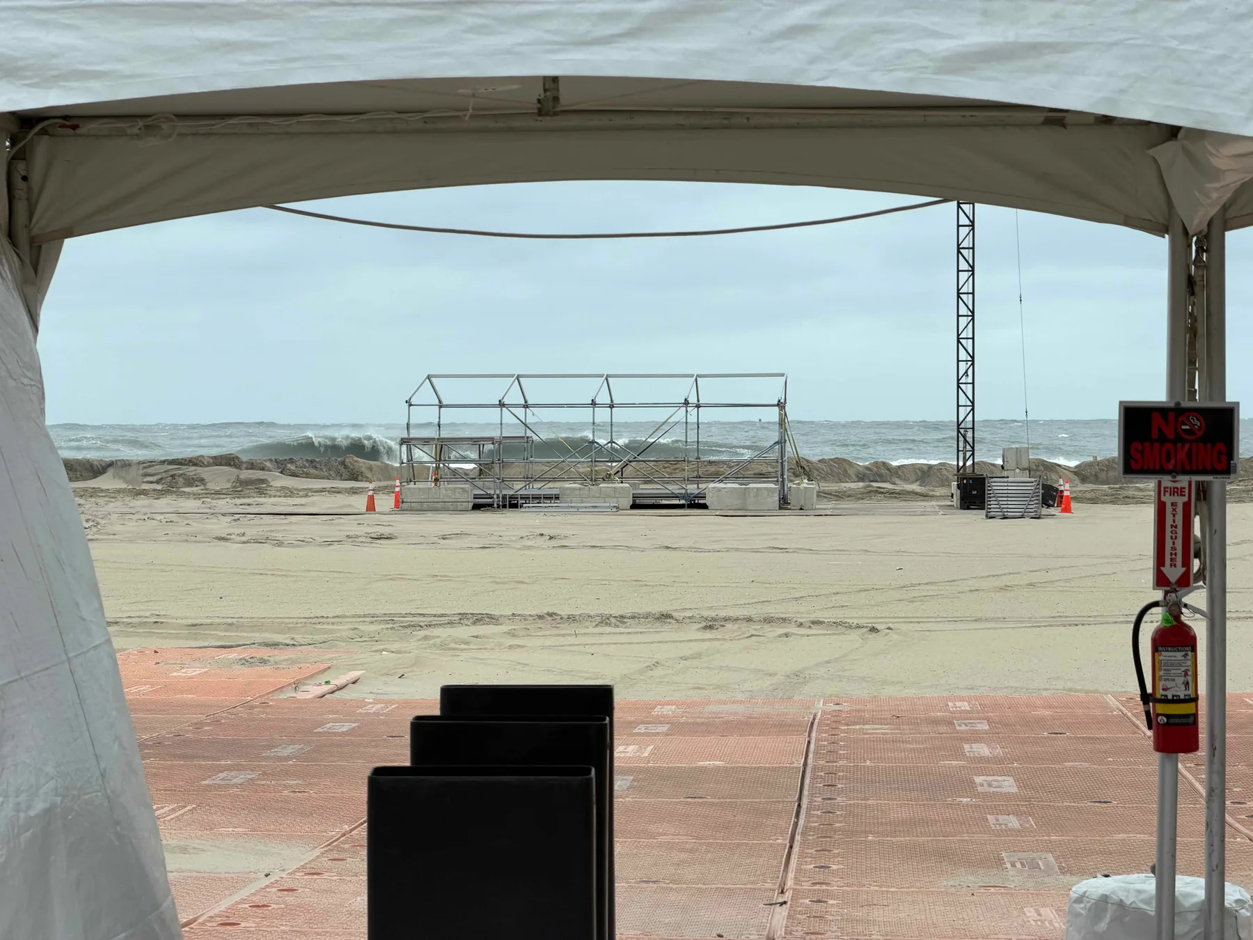 big surf behind a deserted tent on the grounds of the Oceans Calling festival area