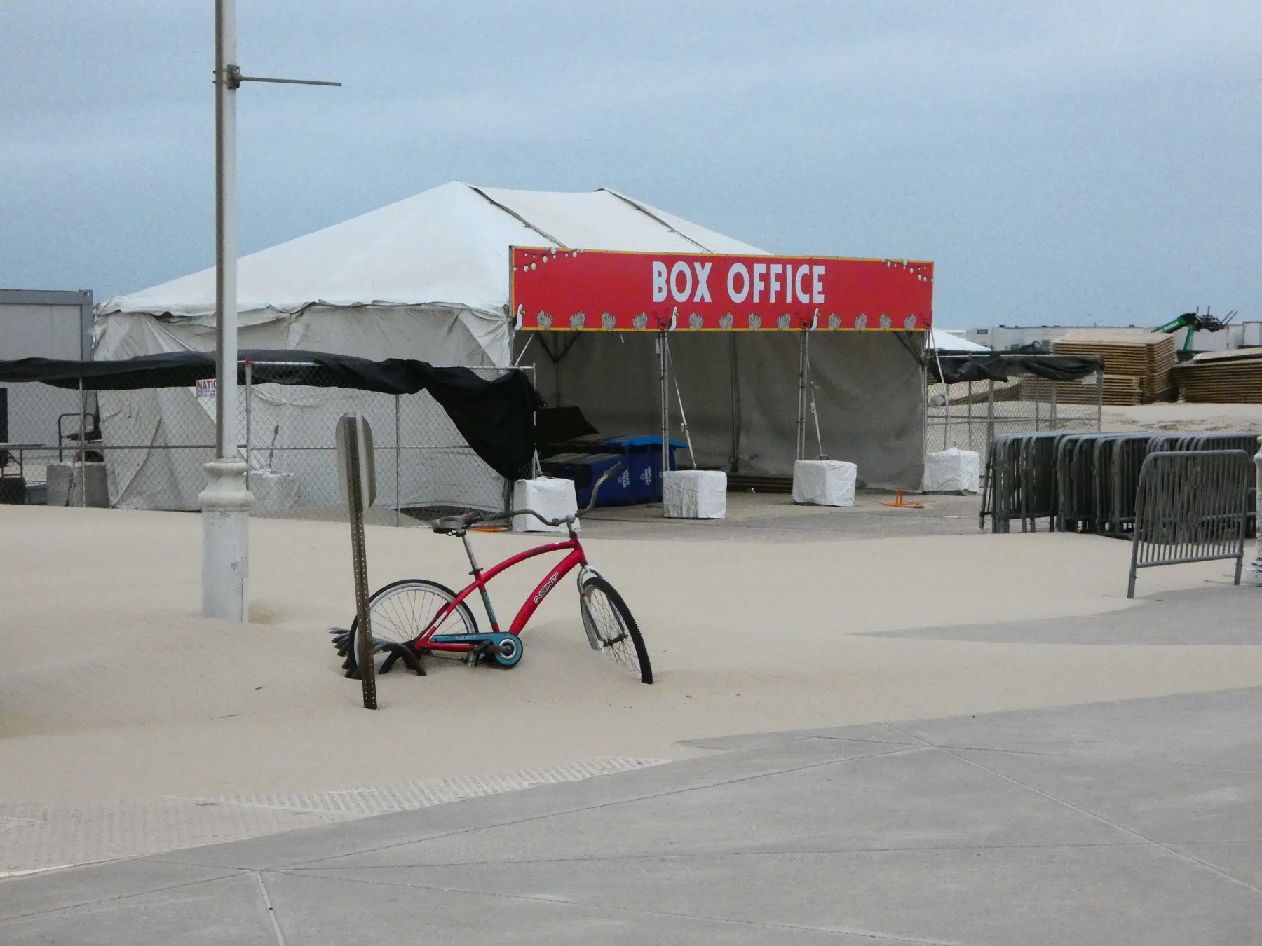 Bike in the sand and the Box Office tent at Oceans Calling