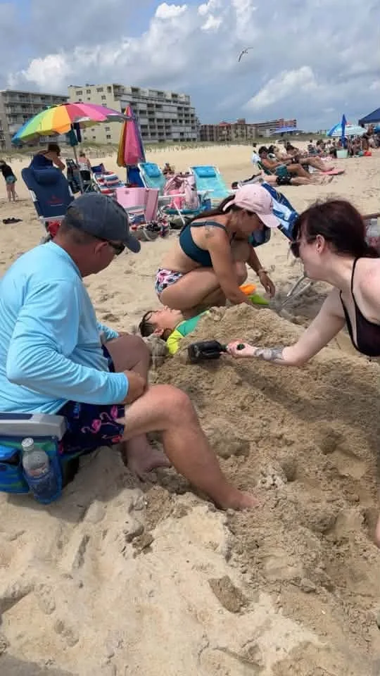 Trent Moore - Burying my nephew in the sand loll
