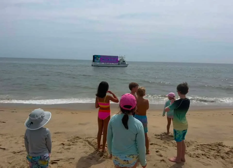 Kate Elaine - Mae just turned 9 last week! Most people complain about summer birthdays but she doesn’t! Every year, we throw her an OC beach birthday bash with friends, cupcakes, Pizza Tugos delivered to the beach, and her name on The Seaboard!