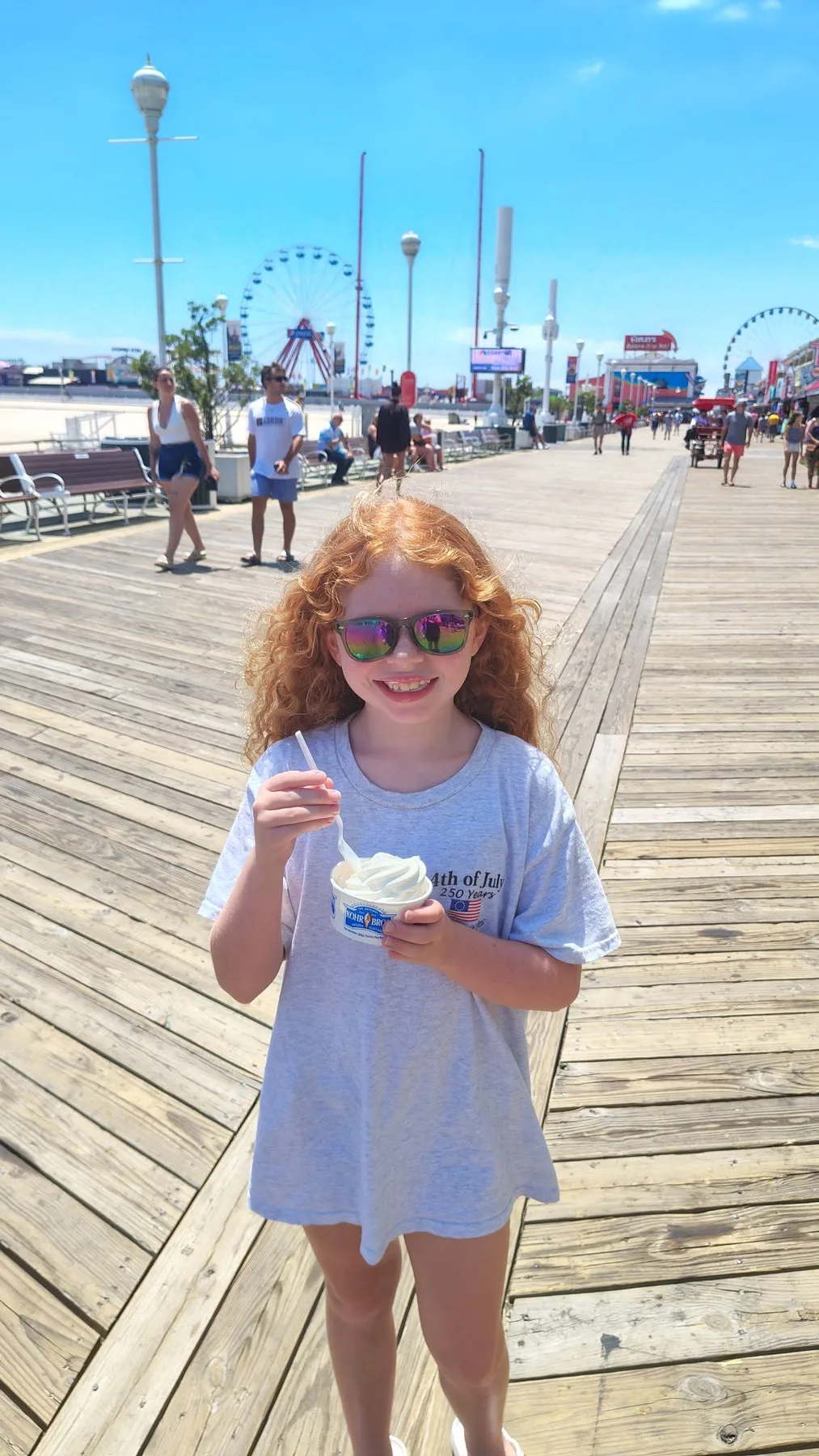 girl on the boardwalk eating ice cream