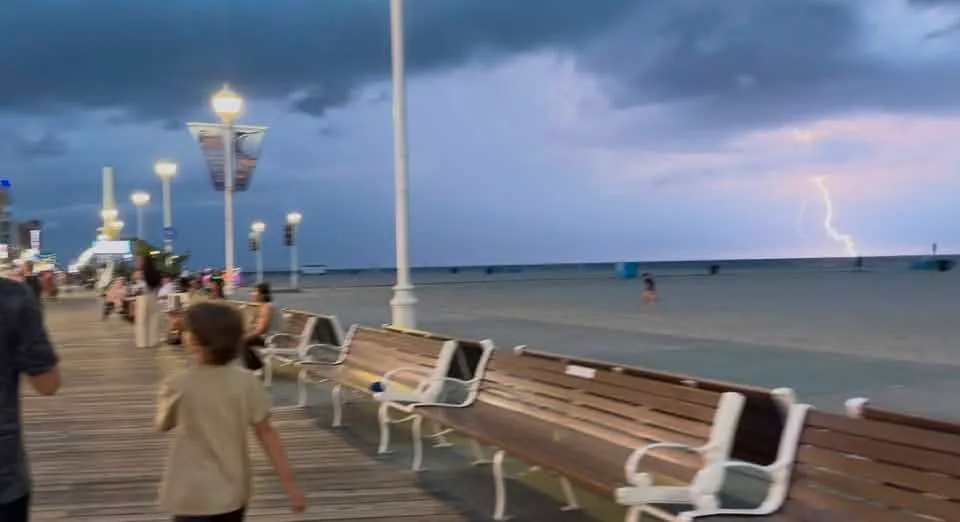 Ashley Rine - Hurrying back to our condo when the storm was approaching on Monday with my boys snapping pics trying to get the lightening.