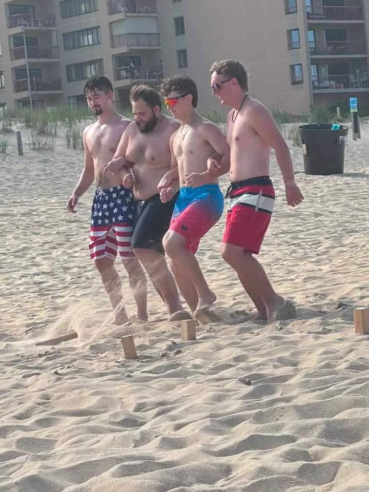men on the ocean city beach line dancing