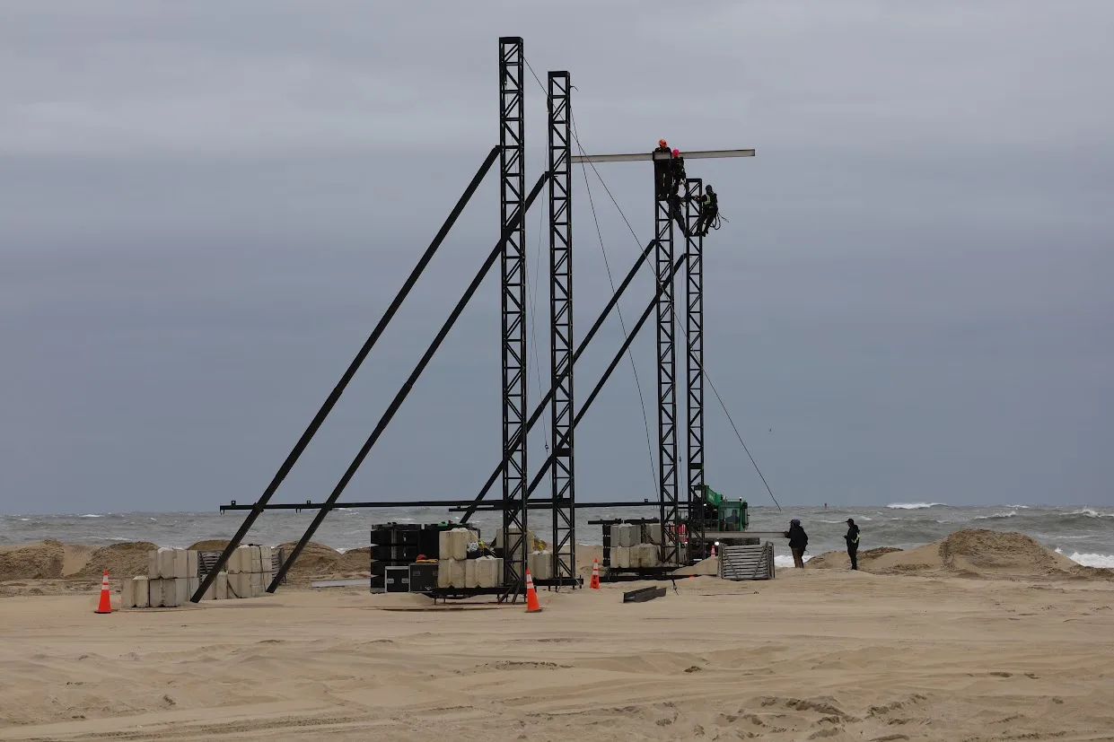 Workers climb the Seabright Stage to secure what they can amid the cancelled Oceans Calling 2026.