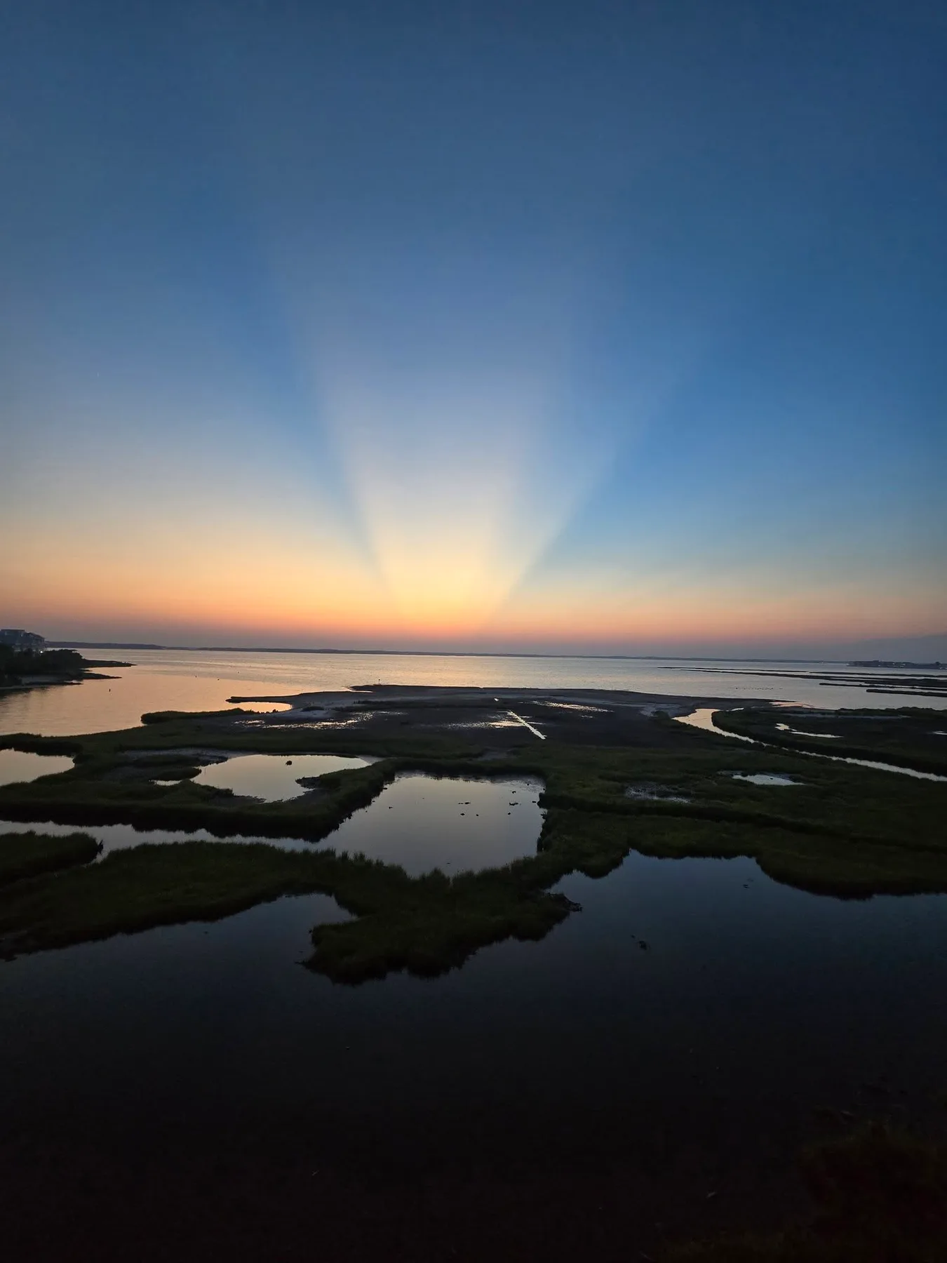 sun setting over the bay in ocean city md