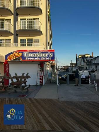 New Thrashers sign being installed on boardwalk at 9th Street